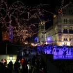 Christmas skaters at the Natural History Museum in London, with lights in the trees.